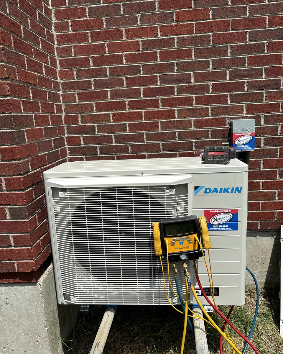 Ductless mini split being commissioned with digital gauges